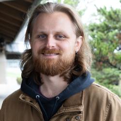 A man with long hair and a redish beard.